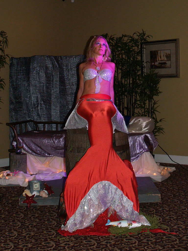Meghan the Mermaid posing on a barrel